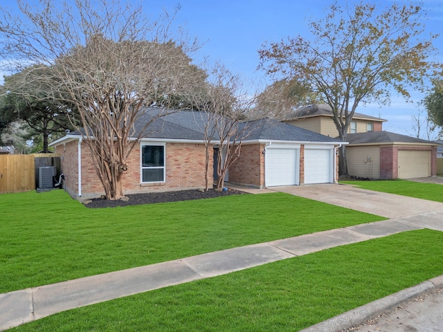 view of front facade with central AC, a garage, and a front lawn