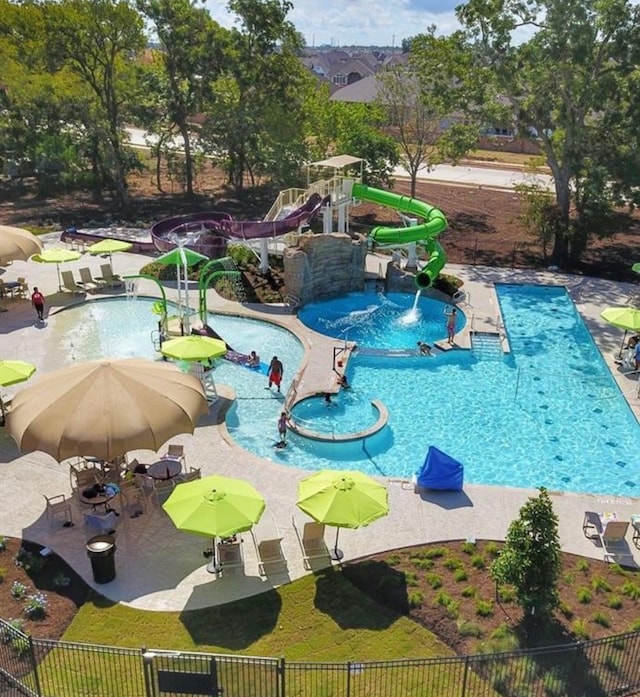 view of swimming pool featuring a patio, a water slide, and a jacuzzi