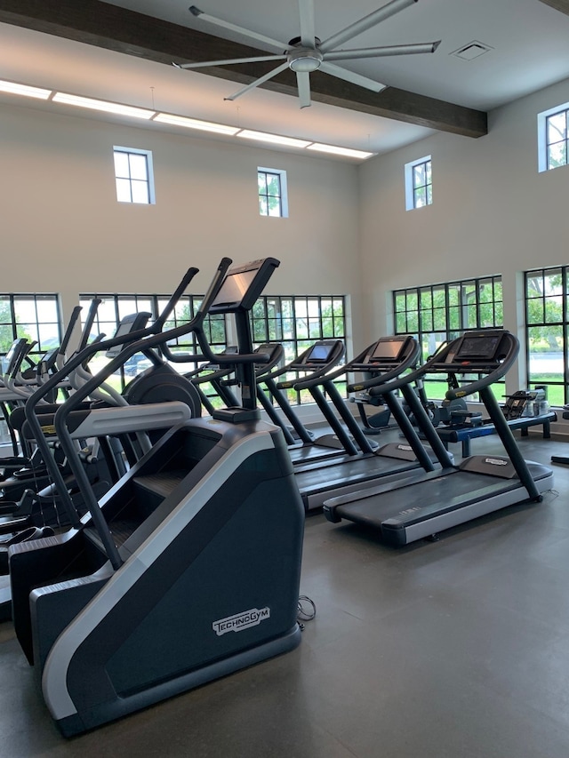 gym featuring a high ceiling and ceiling fan