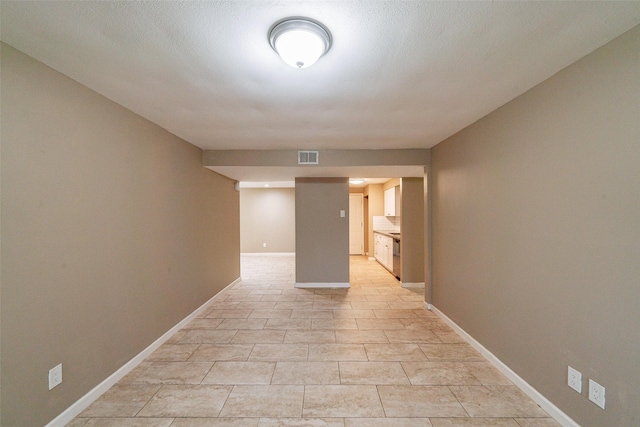 hall featuring a textured ceiling