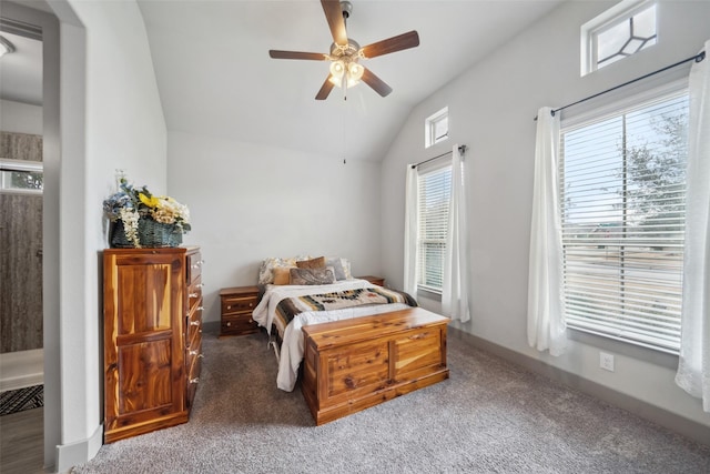 carpeted bedroom with ceiling fan and vaulted ceiling