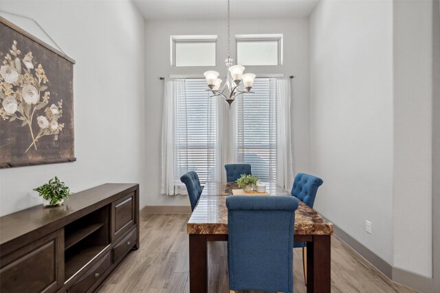 dining room with an inviting chandelier and light wood-type flooring