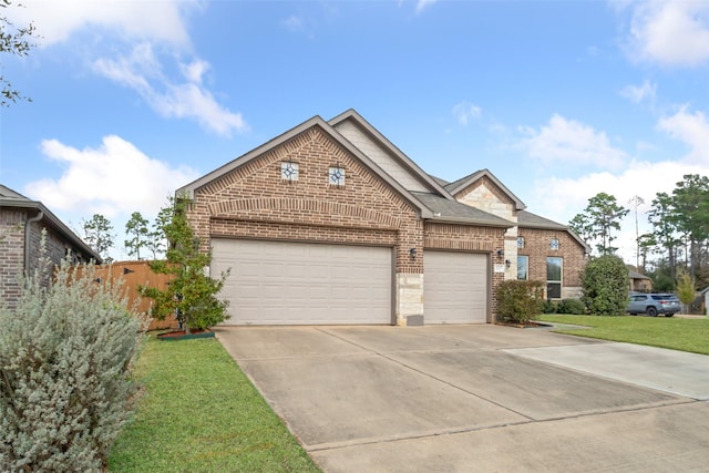 view of front facade featuring driveway, a shingled roof, a front yard, an attached garage, and brick siding