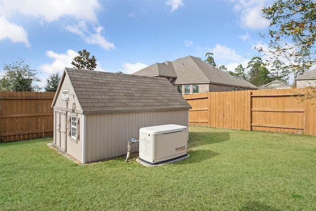 view of yard featuring a storage unit, a fenced backyard, and an outdoor structure