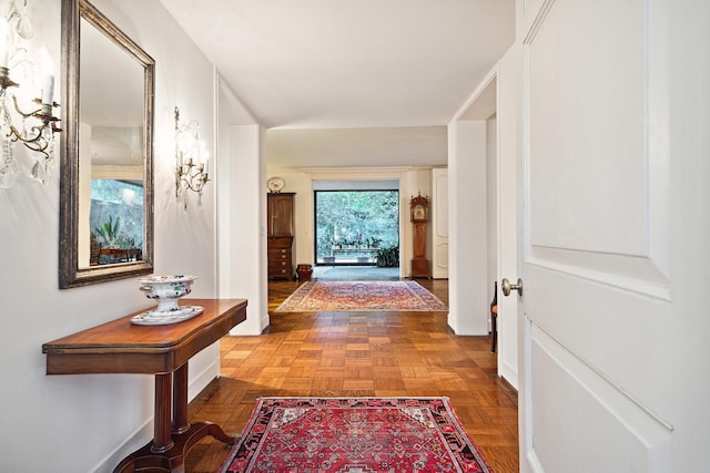 hall featuring parquet flooring