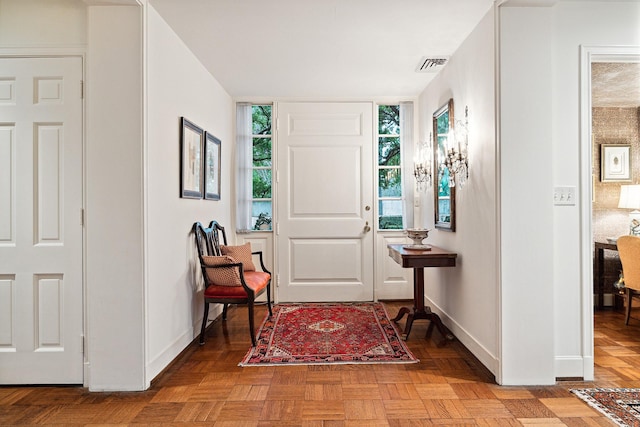 foyer entrance featuring parquet flooring