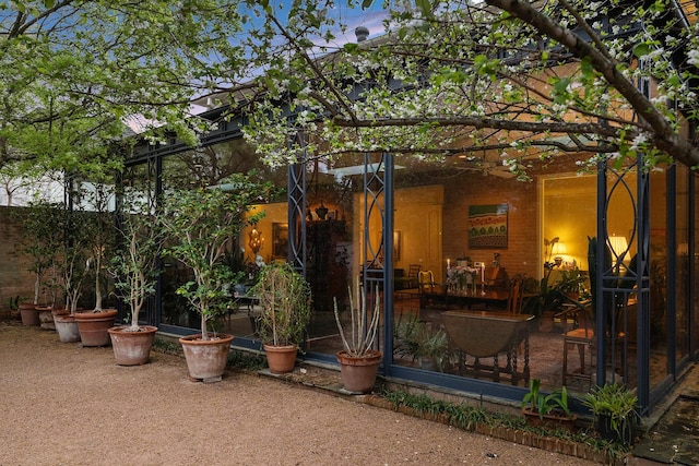 back house at dusk with a patio area