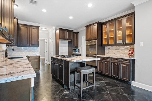 kitchen featuring sink, a center island, dark brown cabinetry, stainless steel appliances, and crown molding