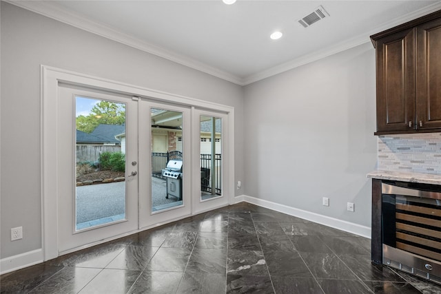 doorway to outside with ornamental molding, wine cooler, and french doors