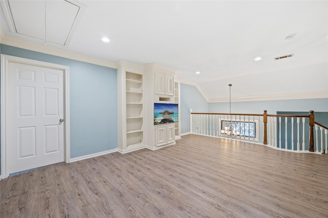 unfurnished living room with built in features, lofted ceiling, and light hardwood / wood-style flooring