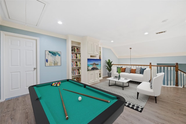 recreation room featuring lofted ceiling, light hardwood / wood-style flooring, ornamental molding, and billiards