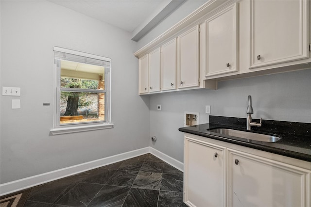 washroom with sink, hookup for a washing machine, cabinets, and hookup for an electric dryer