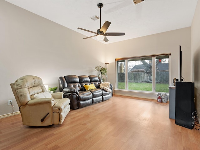 living room with visible vents, a ceiling fan, and wood finished floors