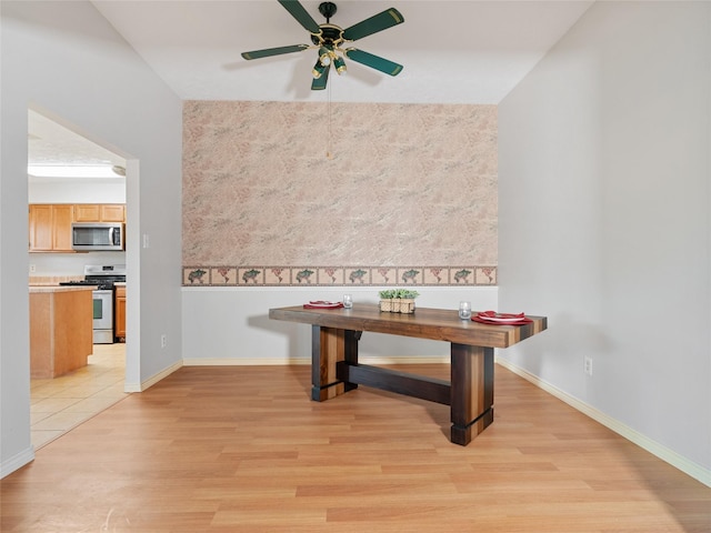 dining space with ceiling fan and light hardwood / wood-style floors