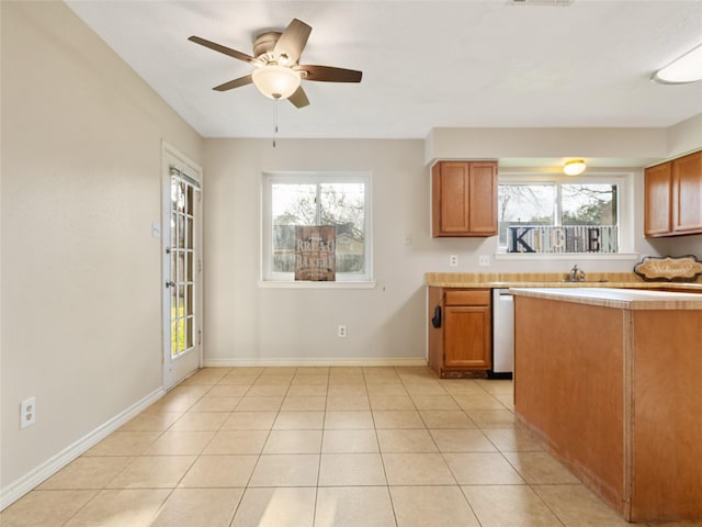 kitchen featuring light tile patterned flooring, dishwasher, and ceiling fan