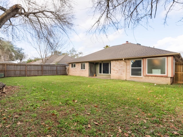 rear view of house with a lawn