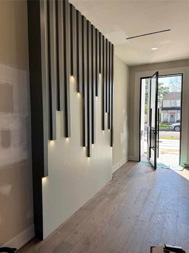 entrance foyer with light wood finished floors and baseboards