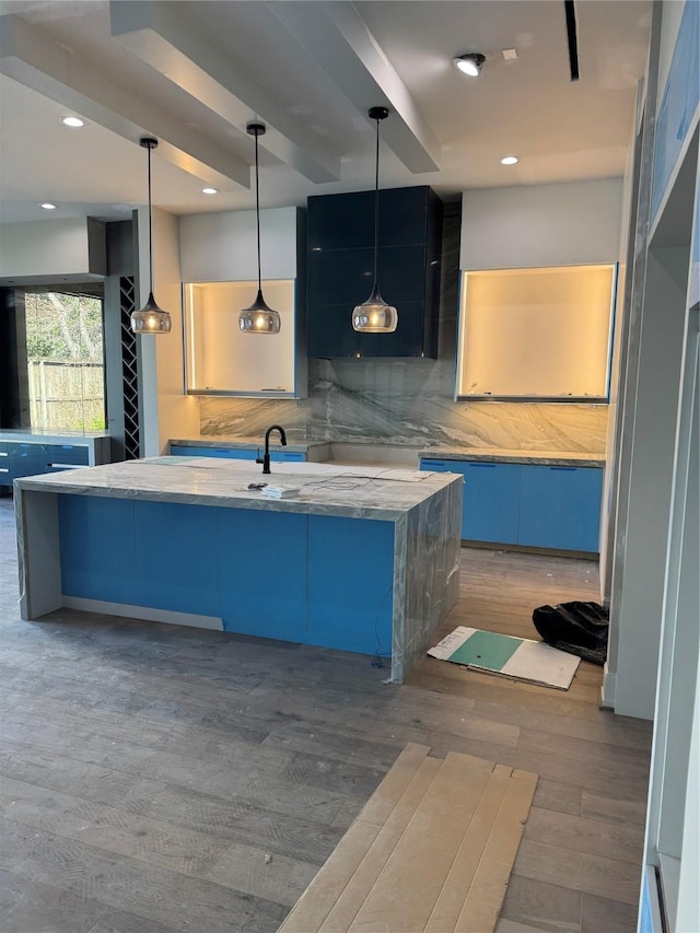 kitchen with decorative backsplash, dark wood-type flooring, hanging light fixtures, a sink, and recessed lighting