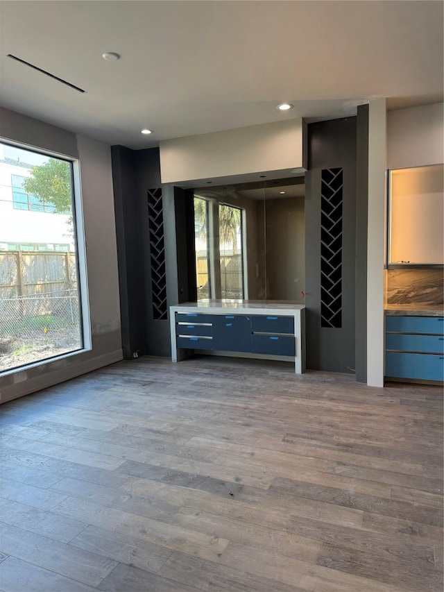 bar featuring light wood finished floors and recessed lighting