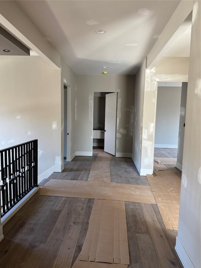 unfurnished room featuring baseboards and wood finished floors