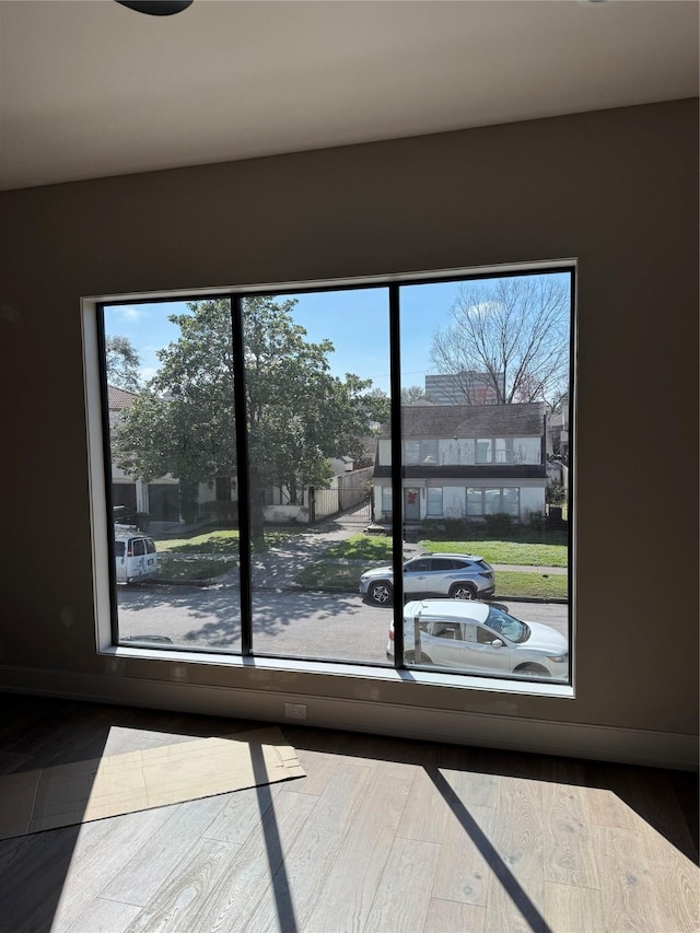 entryway with baseboards and wood finished floors