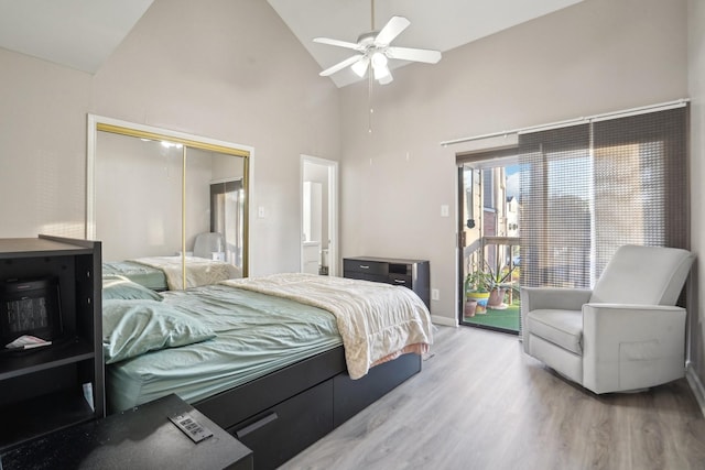 bedroom featuring hardwood / wood-style flooring, ceiling fan, high vaulted ceiling, access to outside, and a closet