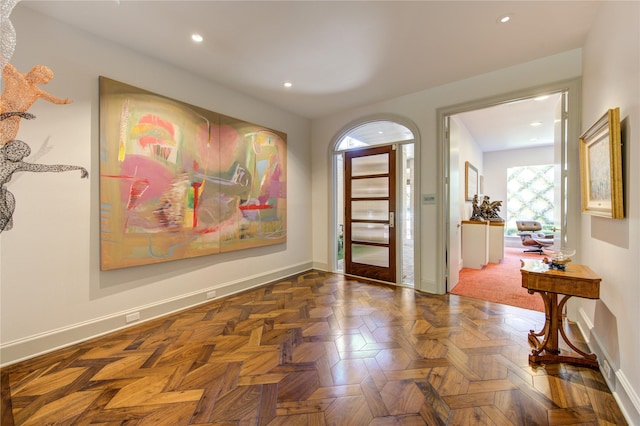 foyer entrance with dark parquet floors