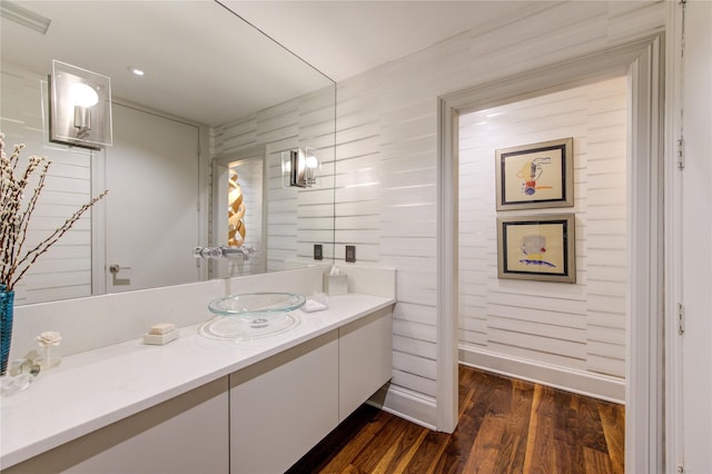 bathroom with visible vents, wood finished floors, and vanity