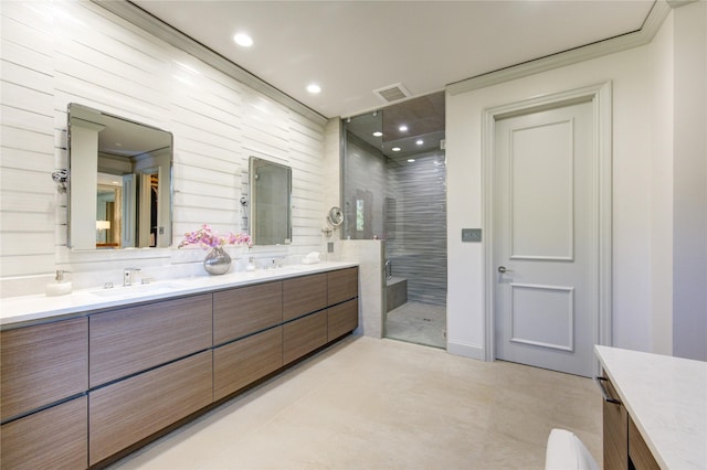 full bathroom with visible vents, double vanity, recessed lighting, a stall shower, and a sink