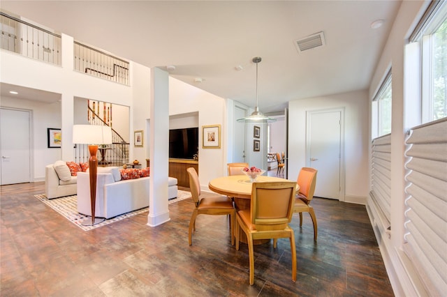 dining room with dark wood finished floors, stairway, baseboards, and visible vents