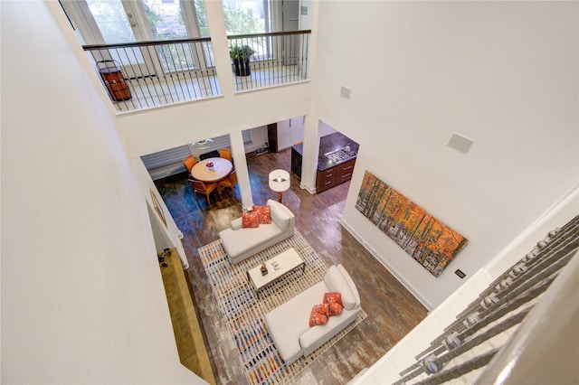 interior space featuring wood finished floors and a towering ceiling