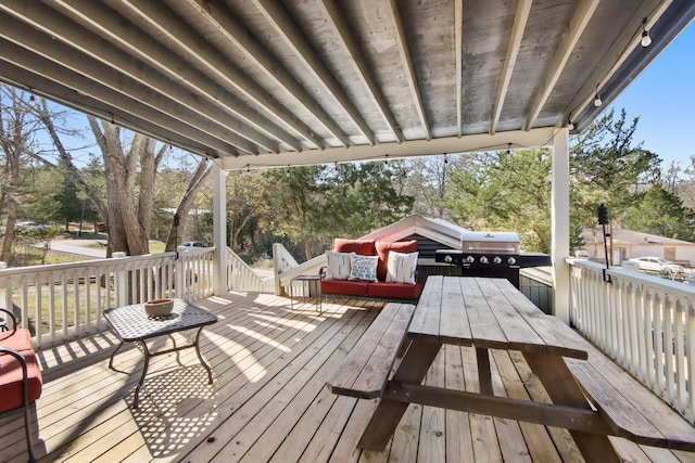 wooden deck featuring a grill and an outdoor hangout area