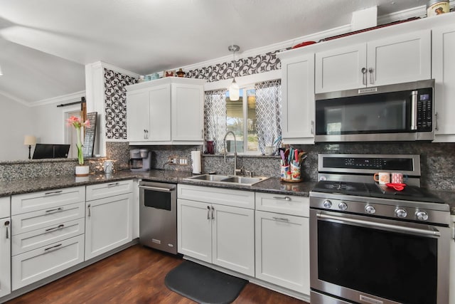 kitchen featuring white cabinetry, sink, backsplash, ornamental molding, and stainless steel appliances