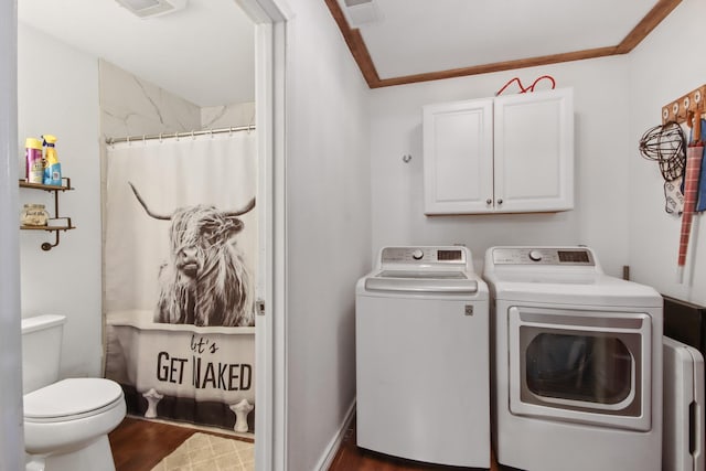 laundry room with ornamental molding, dark hardwood / wood-style flooring, and washer and dryer