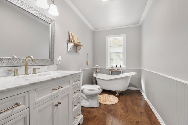 bathroom featuring a washtub, vanity, hardwood / wood-style flooring, and ornamental molding