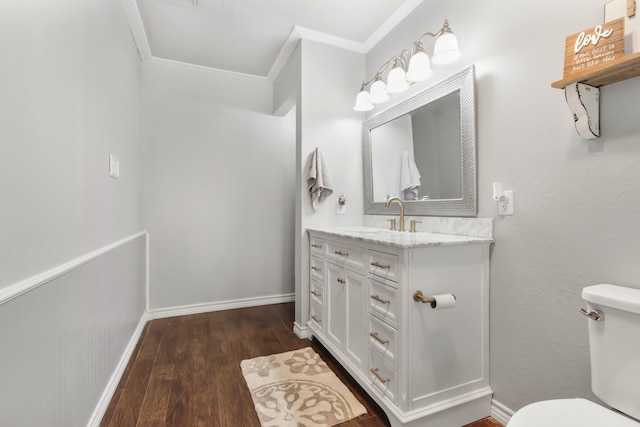 bathroom featuring crown molding, hardwood / wood-style floors, vanity, and toilet