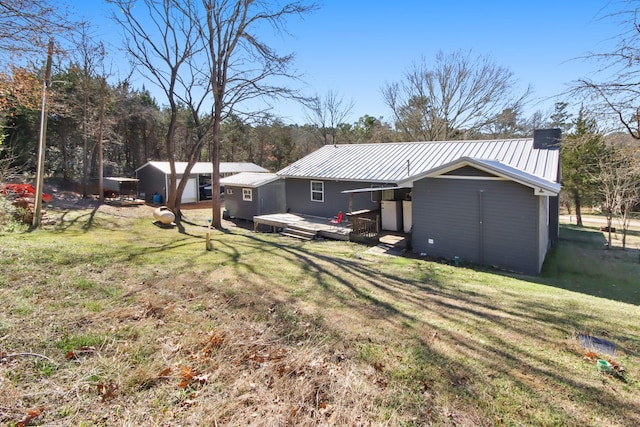 back of house with a yard and a deck