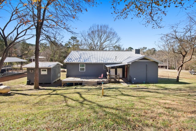 back of house featuring a storage unit, a yard, and a deck