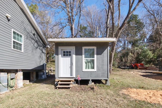 view of outbuilding with a yard