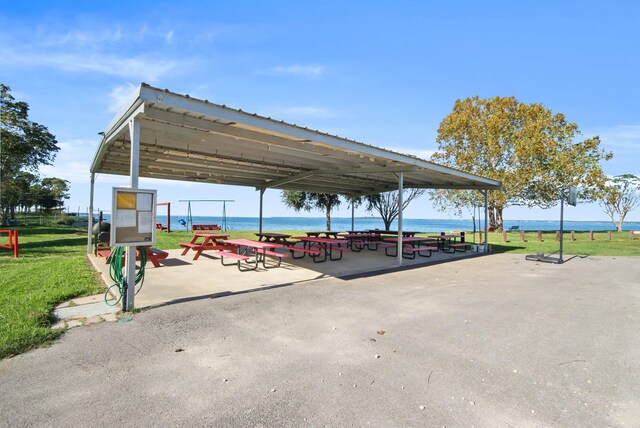 surrounding community featuring a yard and a water view