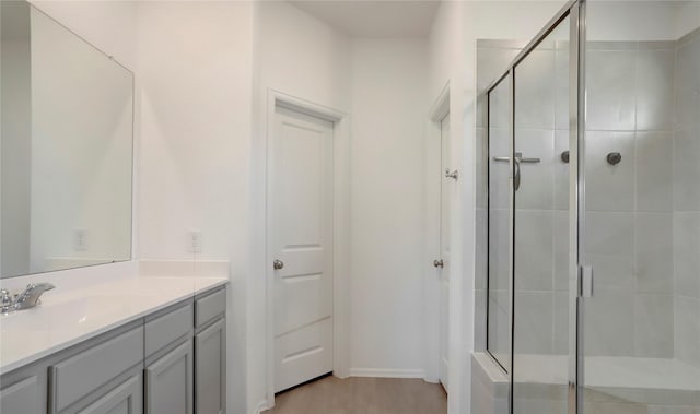 bathroom with walk in shower and vanity