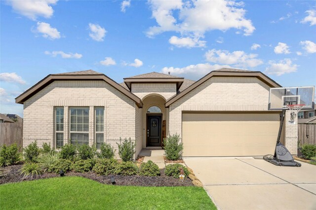 view of front of house with a garage and a front lawn