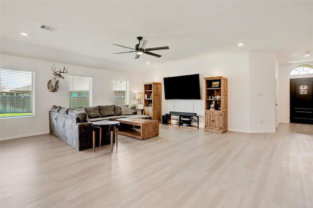 living room with ceiling fan and light hardwood / wood-style flooring