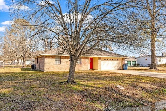 single story home featuring a garage, a front yard, and central air condition unit