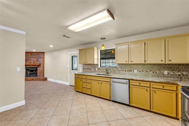 kitchen featuring dishwasher, sink, light tile patterned floors, and decorative backsplash