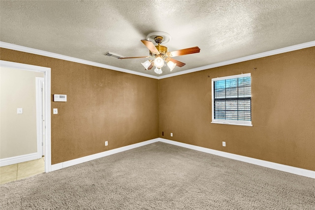 carpeted spare room with ceiling fan, ornamental molding, and a textured ceiling