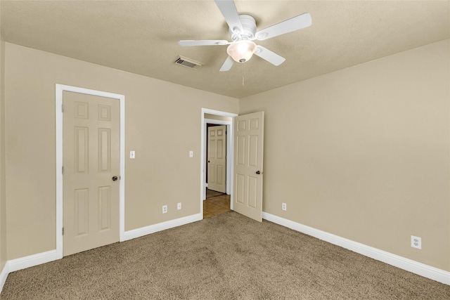 unfurnished bedroom with ceiling fan, carpet flooring, and a textured ceiling