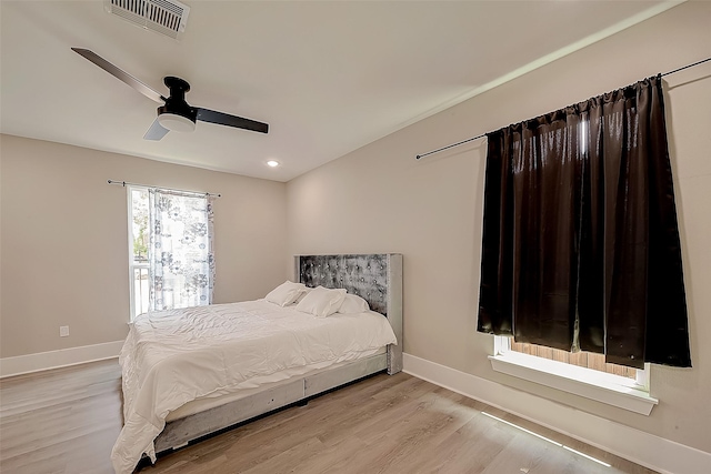 bedroom with ceiling fan and light hardwood / wood-style floors