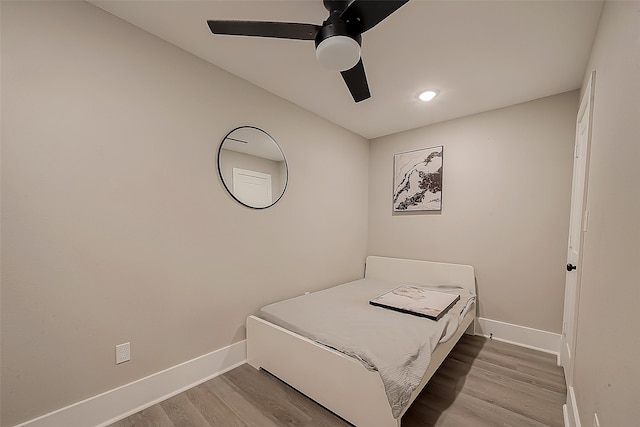 bedroom with hardwood / wood-style flooring and ceiling fan