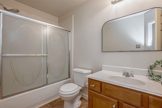 full bathroom featuring tile patterned floors, vanity, toilet, and combined bath / shower with glass door